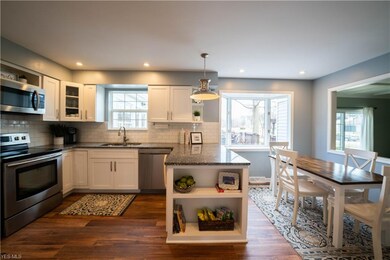 Newly remodeled kitchen includes pendant light ove