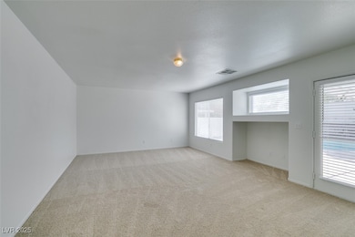 Spare room featuring light colored carpet and base