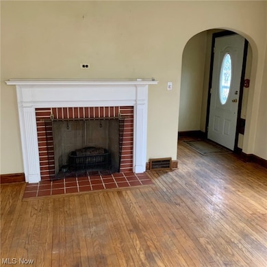 Room details with dark hardwood / wood-style floors and a fireplace