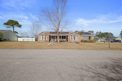 Single story home featuring a front yard, roof mou
