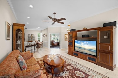 Living area featuring crown molding, light tile patterned floors, a ceiling fan, and recessed lighting