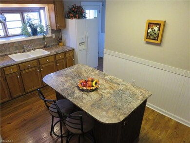 Large kitchen with double sinks, island, oak flooring