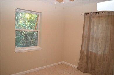 Bedroom 1 offers tile floors, ceiling fan and clos