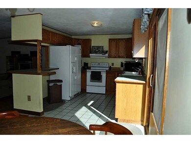 Kitchen. Breakfast bar overlooks family room.