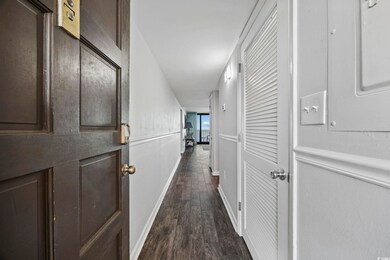 Hall with dark wood-style floors and electric panel
