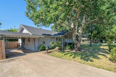 Single story home featuring a front lawn and a carport