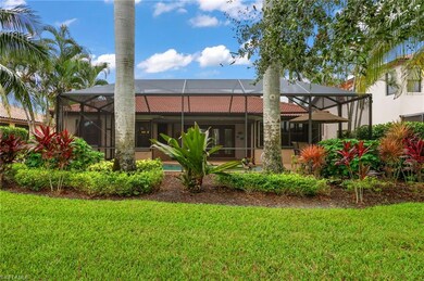 Back of house featuring a yard and a lanai