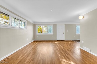 Empty room featuring light hardwood / wood-style floors and a healthy amount of sunlight