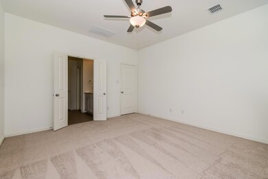 Carpeted spare room featuring ceiling fan