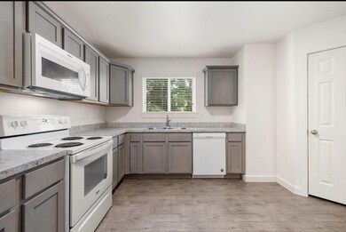 This well-lit kitchen features granite countertops