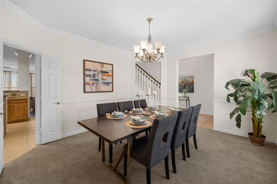 Tiled dining room featuring ornamental molding and
