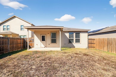 Back of house featuring a patio, a fenced backyard, and roof with shingles