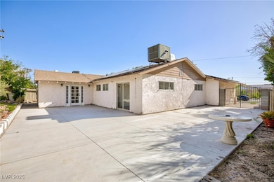 Back of property with stucco siding, a patio, and