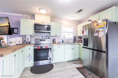 Kitchen featuring appliances with stainless steel