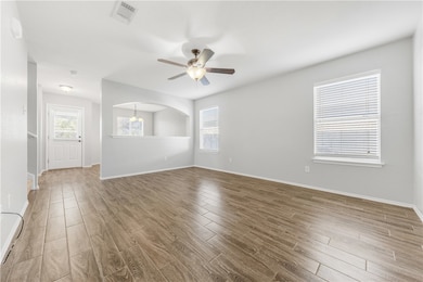 Spare room featuring visible vents, ceiling fan, b
