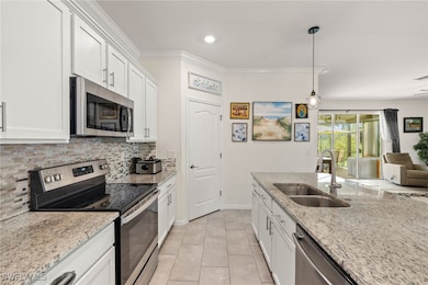 Kitchen with stainless steel appliances, a sink, n