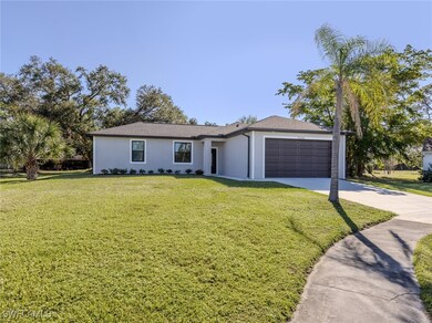 Ranch-style home with an attached garage, driveway