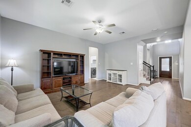 Living area with stairs, wood finished floors, ce