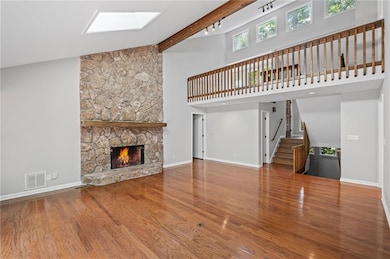 Vaulted ceilings and a floor to ceiling fireplace contribute to the open feel of your great room