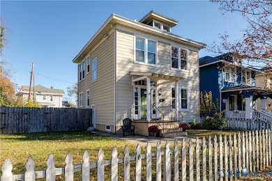Traditional style home featuring a fenced front yard and crawl space