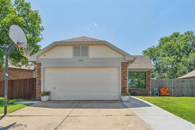 View of front of home featuring brick siding, roof with shingles, concrete driveway, and an attached garage