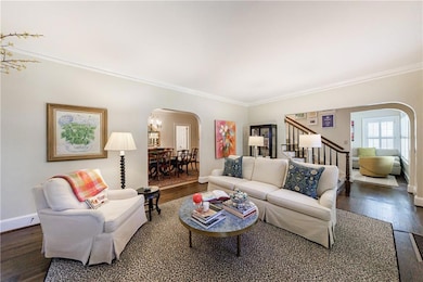 Stairs off the living room lead to the upper two bedrooms and bath