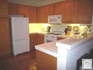 Kitchen opens to dining and living room with count