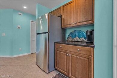 Kitchen with dark stone countertops, stainless ste