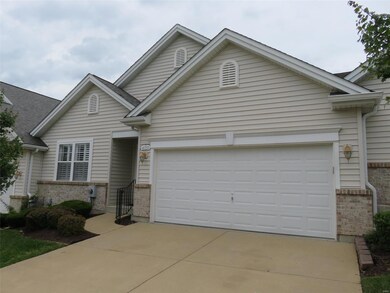 Covered front porch with decorative handrail and two car garage...