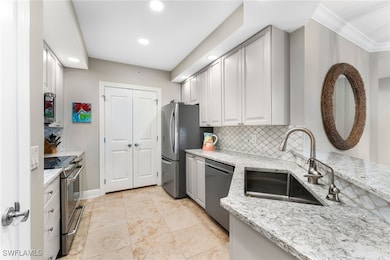 Kitchen featuring light stone countertops, backspl