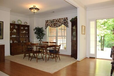 The dining room is open to the foyer & hallway int