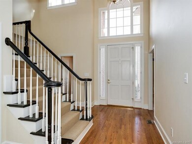 LIGHT-FILLED FOYER ACCENTUATED BY DECORATIVE WINDO