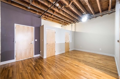 Below grade area with wood finished floors and ba