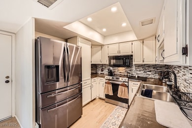 Kitchen with stainless steel appliances, a sink, l