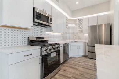 This kitchen will feature white shaker cabinets. C