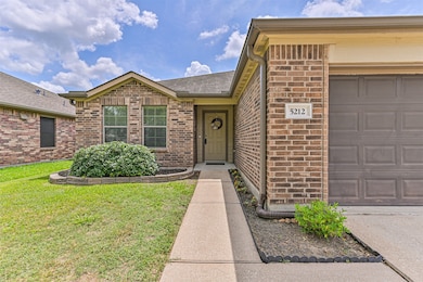 Charming front entry with brick exterior and a wel