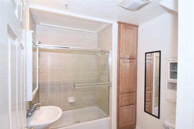 Bathroom with visible vents, toilet, enclosed tub