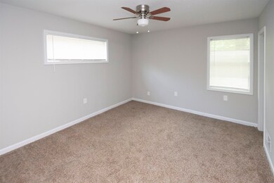 Unfurnished room with ceiling fan and carpet floor