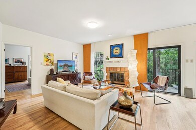 Living room featuring wood finished floors, a wea
