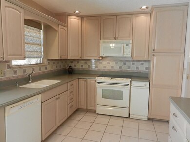 STUNNING! Newer cabinets, solid-surface countertop
