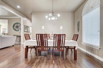 Dining space with a notable chandelier and dark wo
