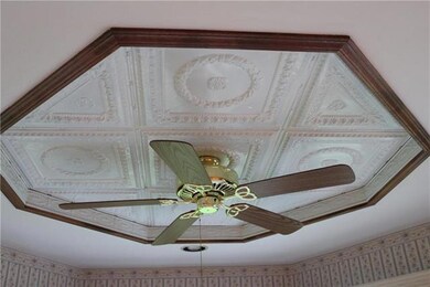 The sunroom ceiling has decorative metal tiles and
