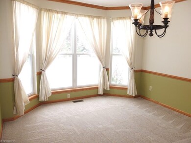 Formal dining room with crown molding, chair rail 