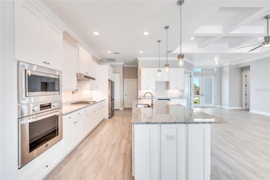 Chefs Kitchen/ Island with built in cabinetry, gas range, pot filler