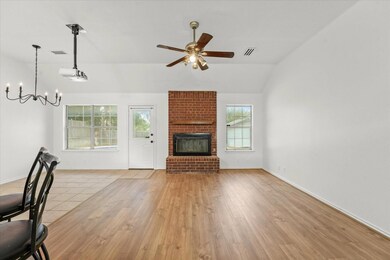 Unfurnished living room featuring lofted ceiling, a healthy amount of sunlight, and light hardwood / wood-style flooring