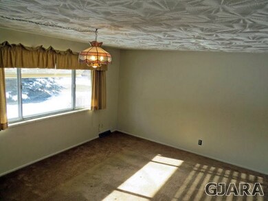 Large formal living room with unique stamped ceili