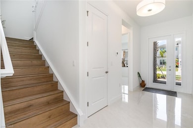 Entryway featuring stairway and baseboards