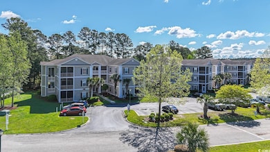 View of property featuring uncovered parking
