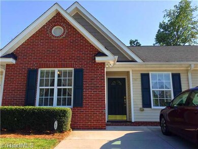 Exterior Front. Nestled in the woods with additional privacy and unit features a double concrete parking pad