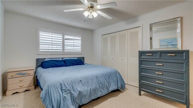 Bedroom with a textured ceiling, a closet, and cei